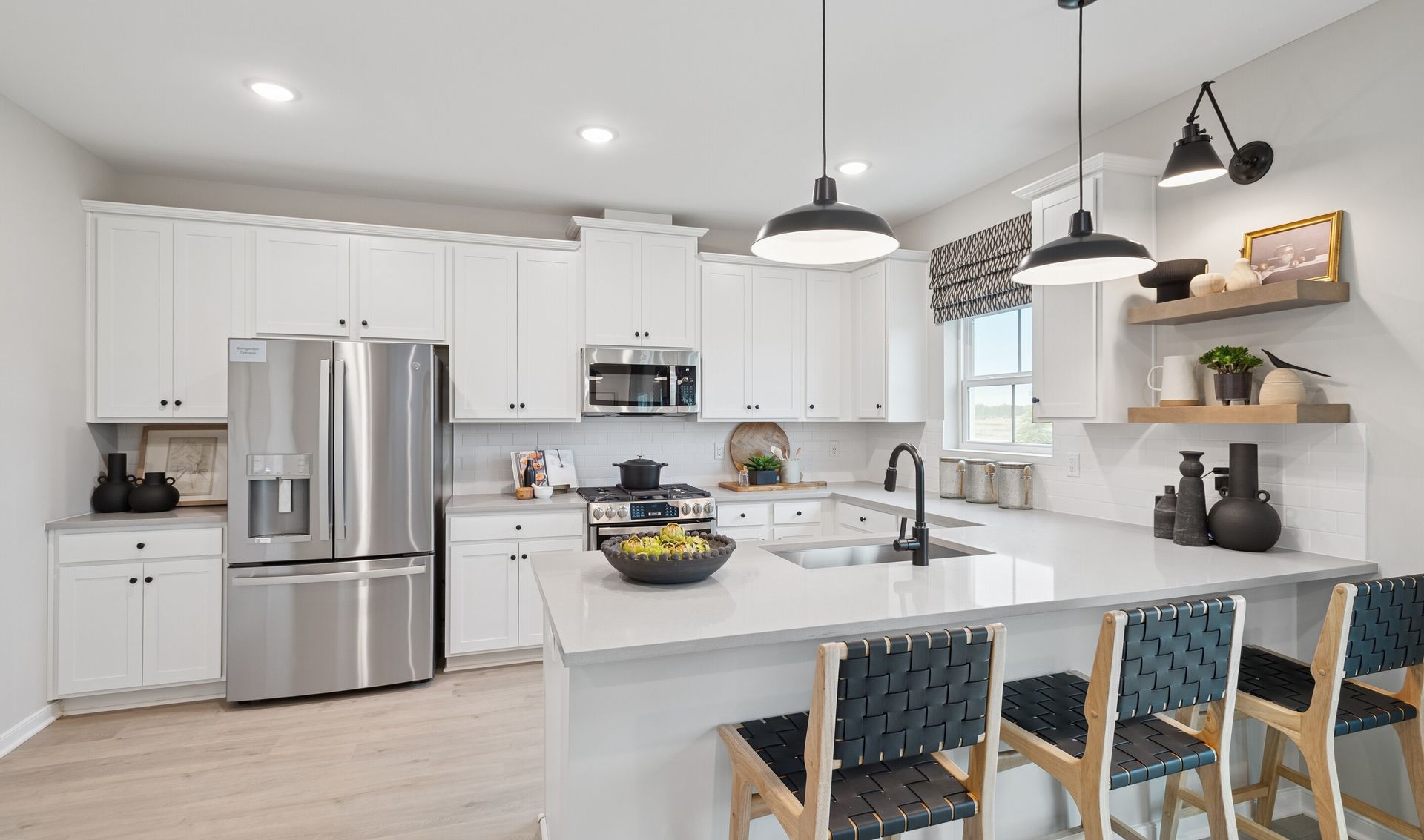Kitchen with pendant lighting over peninsula island