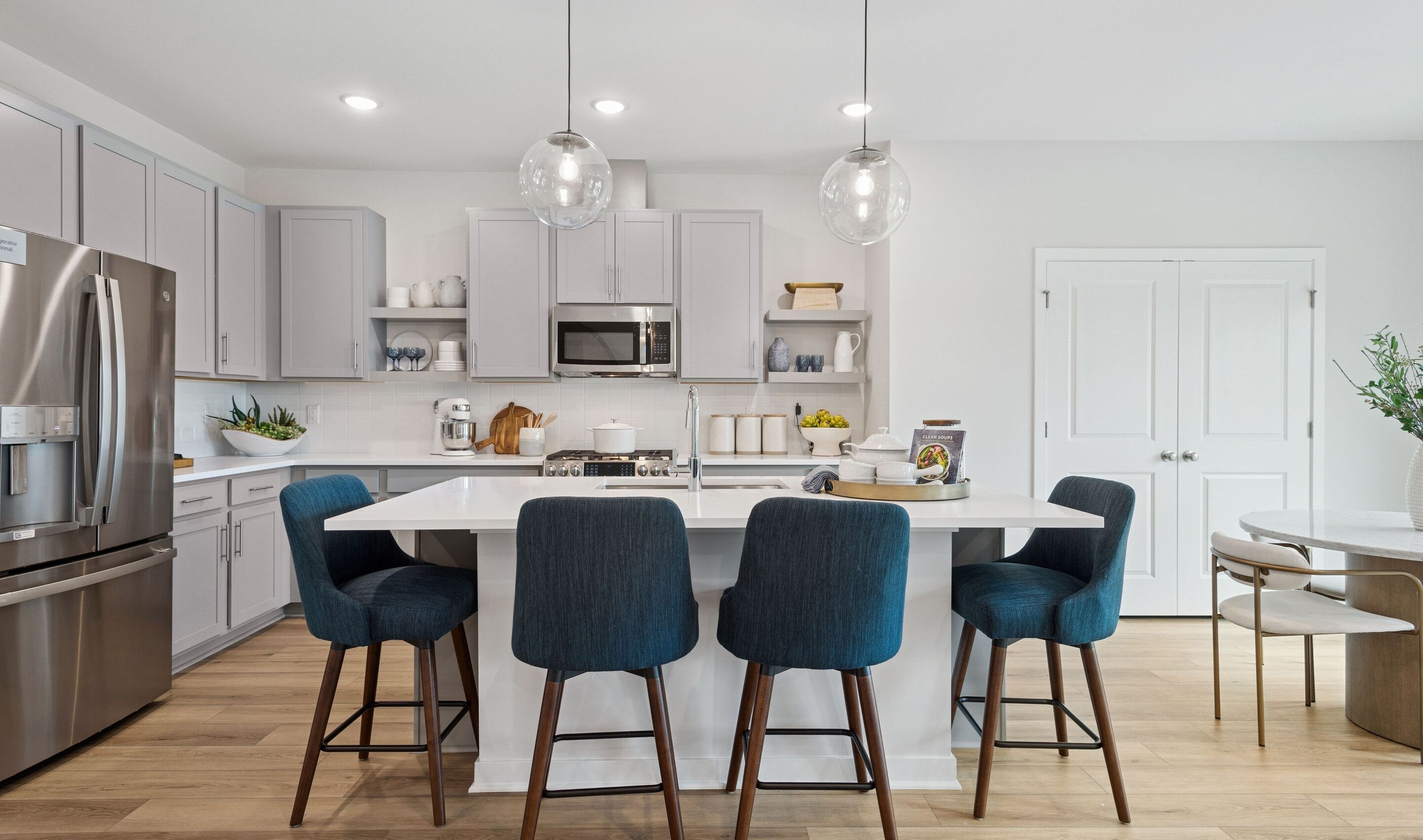 Kitchen with floating shelves and quartz countertops