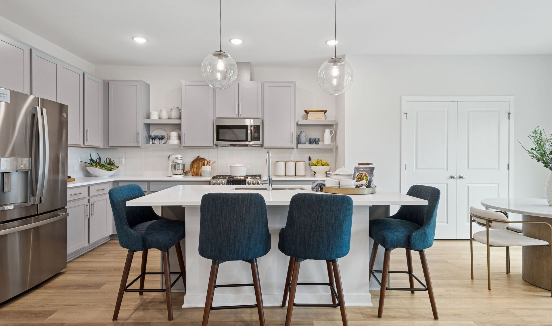 Kitchen with floating shelves and quartz countertops