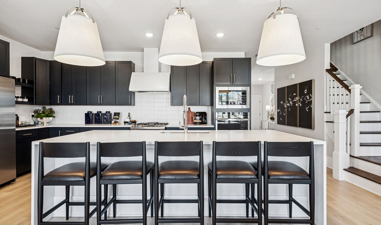 Kitchen with waterfall island and pendant lighting