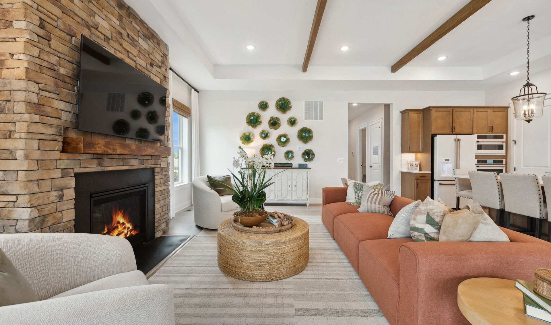 Great room with tray ceiling and stained ceiling beams
