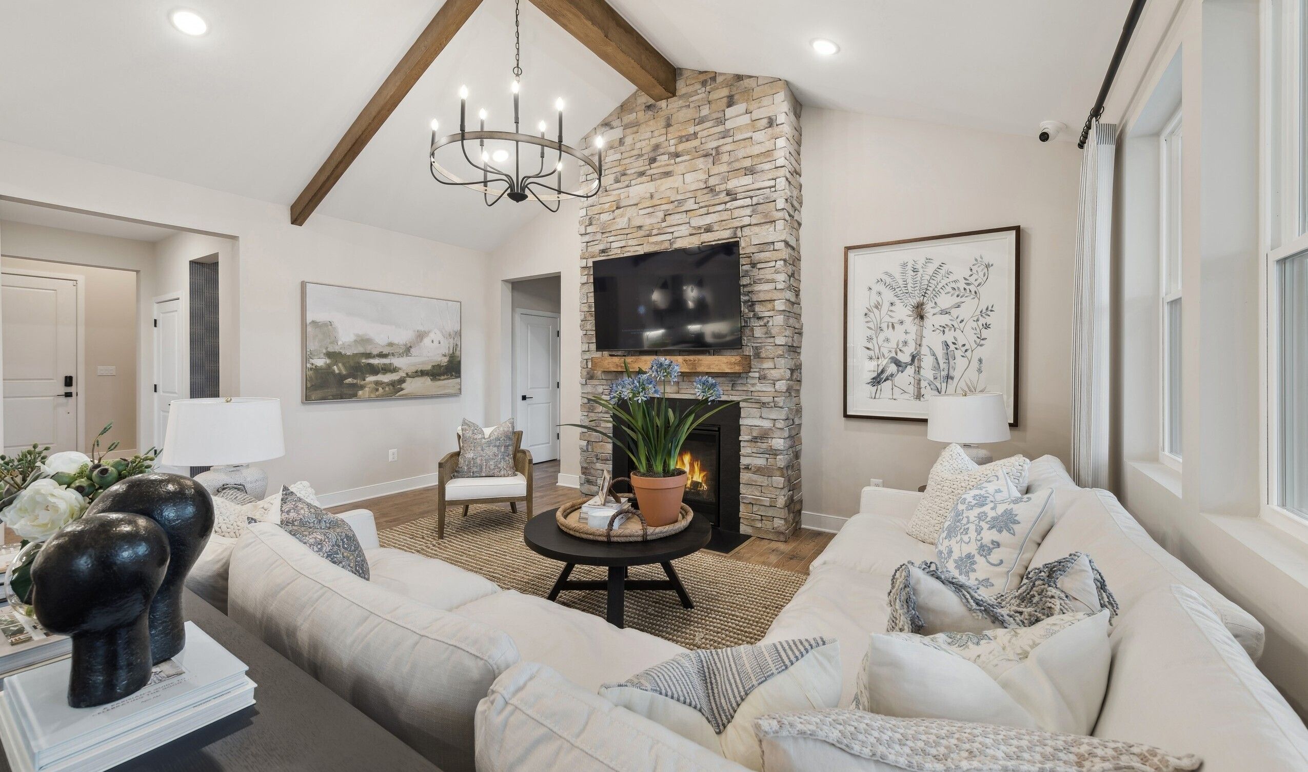 Great room with stained ceiling beams & vaulted ceiling