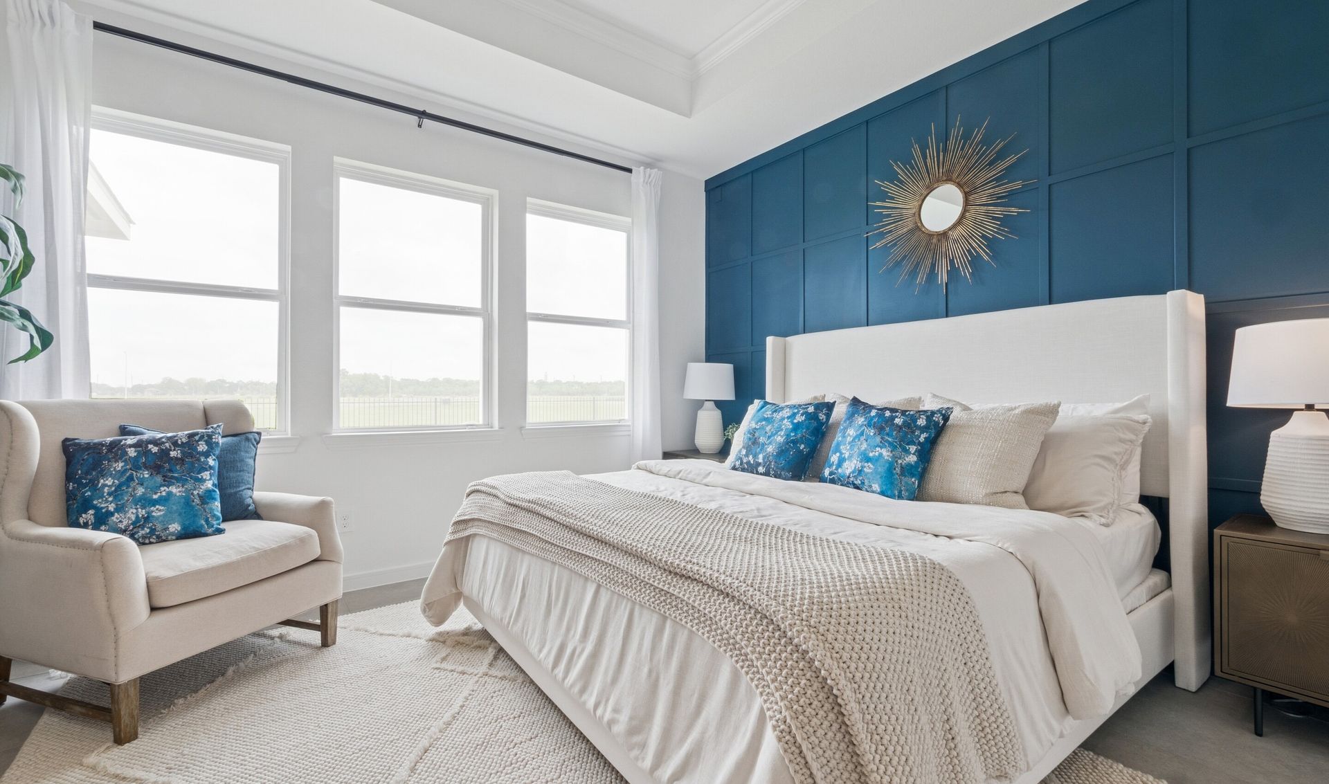 Primary suite with tray ceiling & decorative feature wall