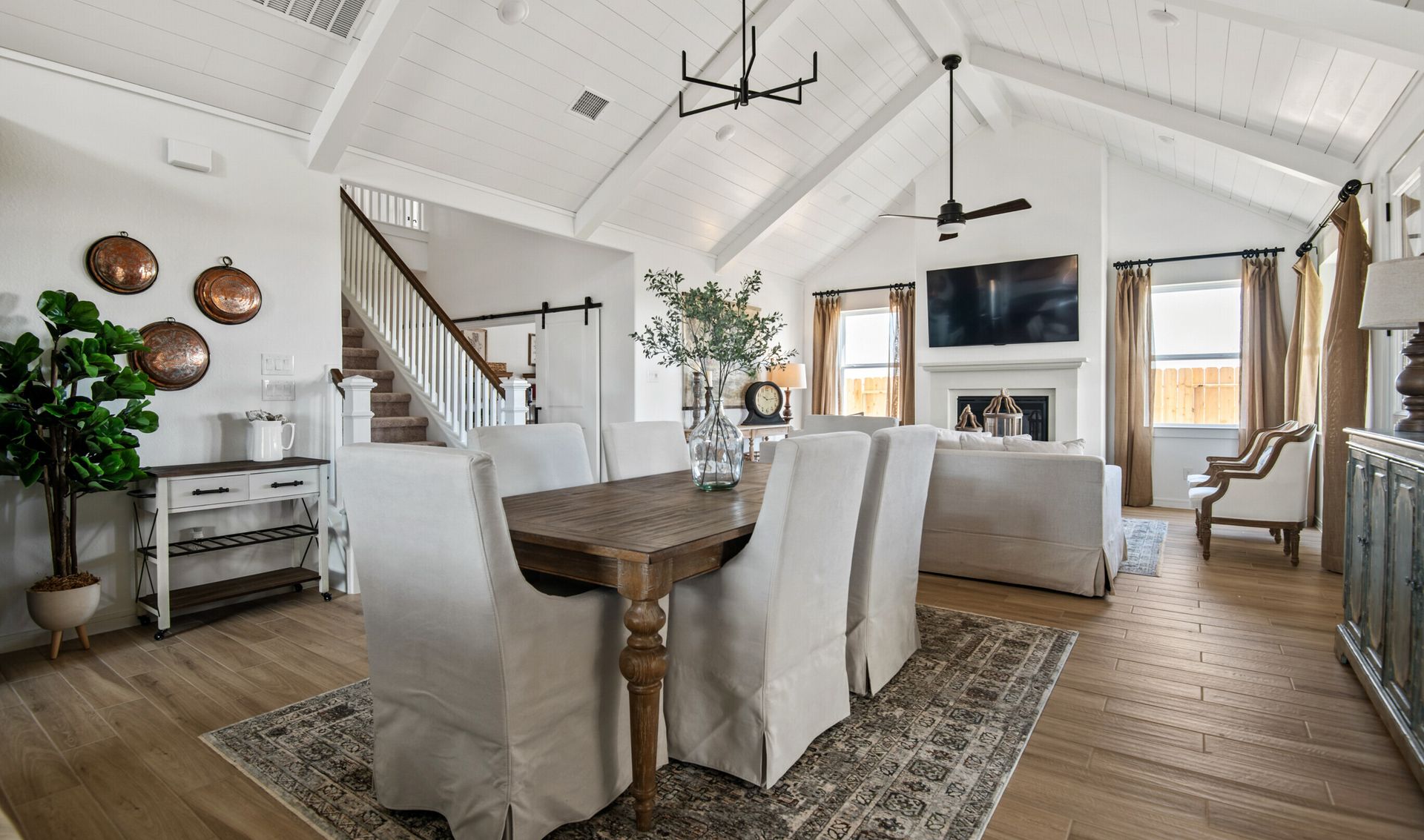 Dining area with vaulted ceiling and white painted ceiling beams