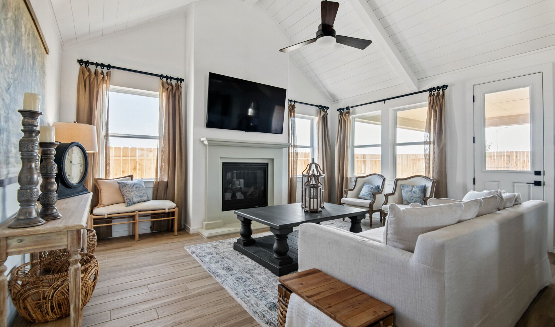 Great room with white painted ceiling beams and shiplap