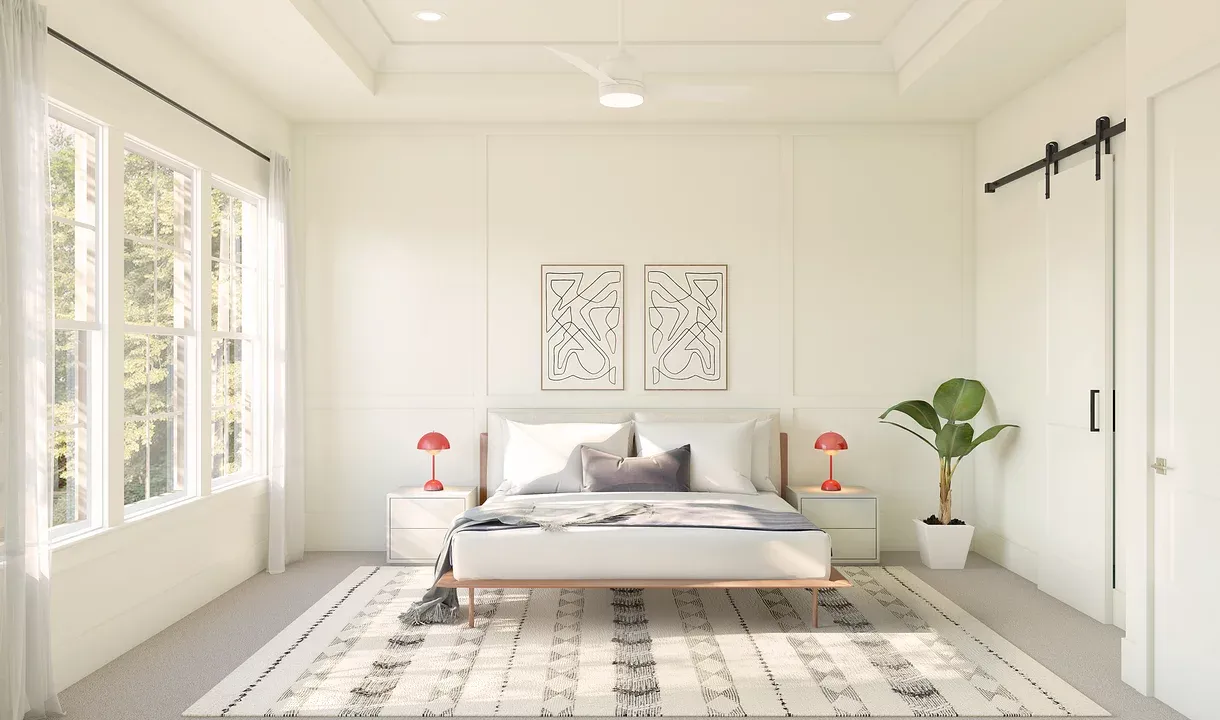 Primary suite with tray ceiling and decorative feature wall