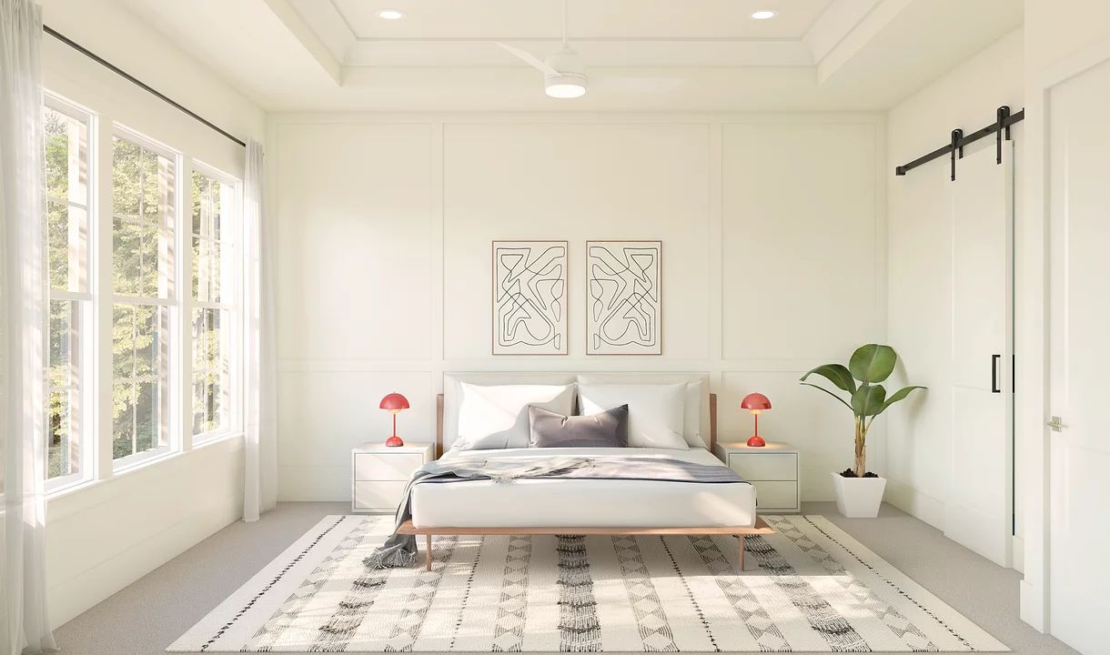 Primary suite with tray ceiling and decorative feature wall