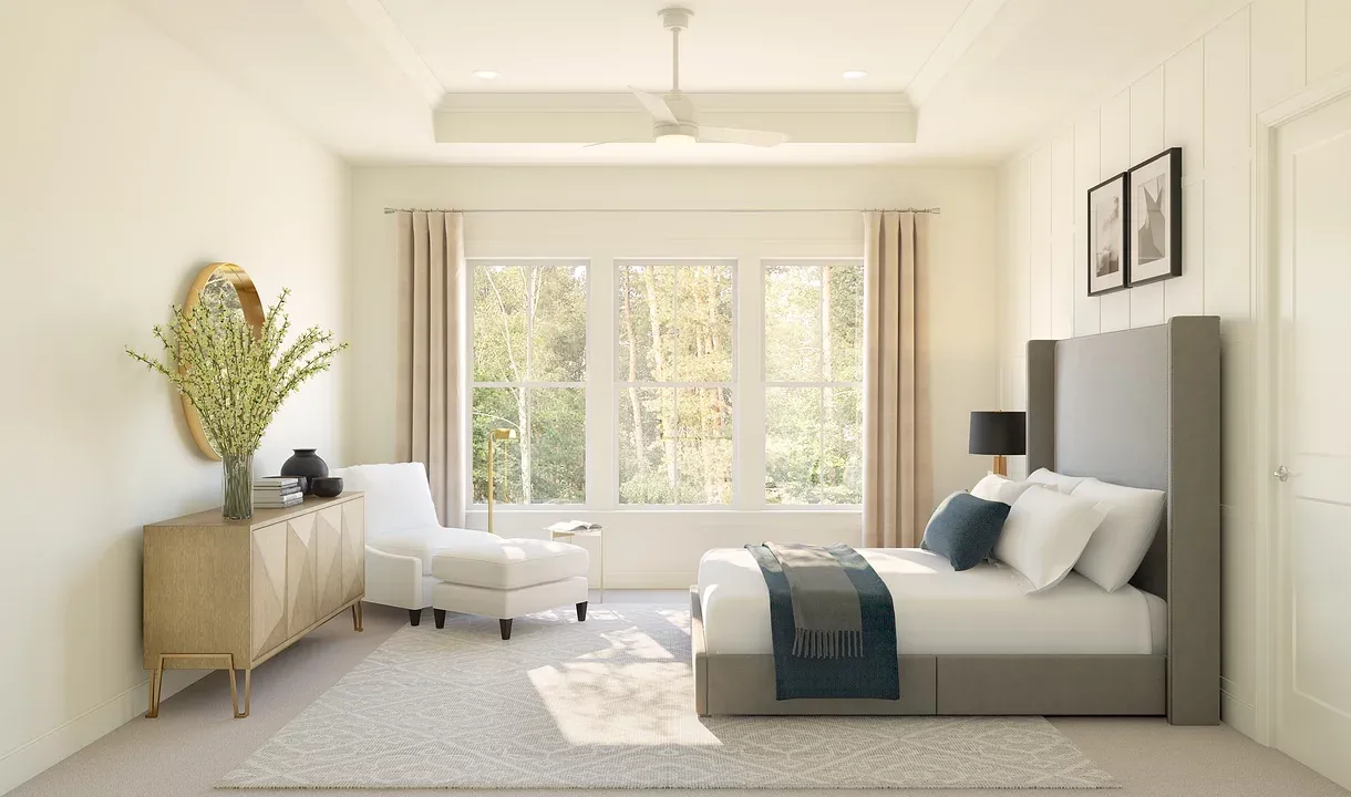 Primary suite with tray ceiling and decorative feature wall