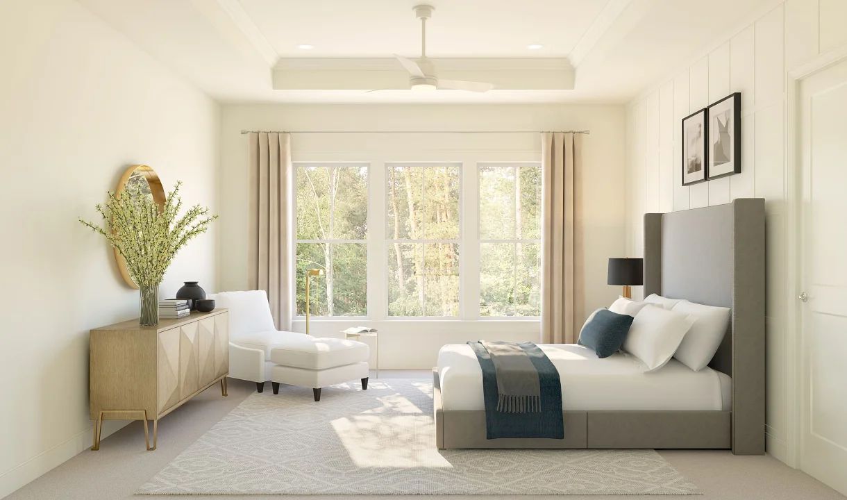Primary suite with tray ceiling and decorative feature wall