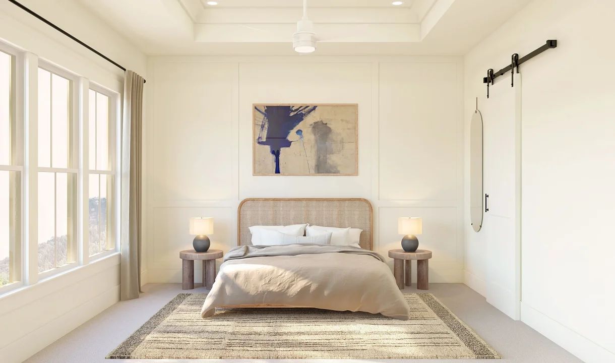 Primary suite with tray ceiling and decorative feature wall