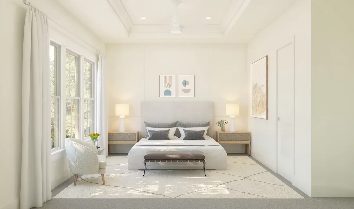Primary suite with tray ceiling and decorative feature wall