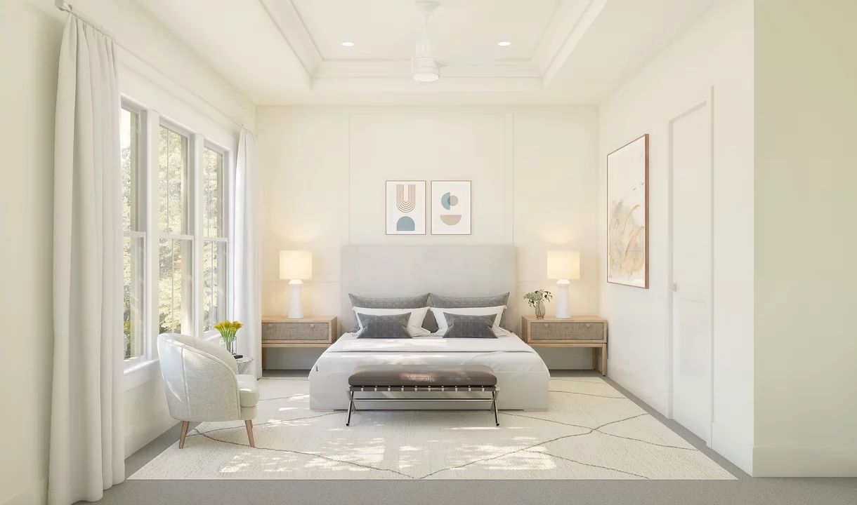 Primary suite with tray ceiling and decorative feature wall