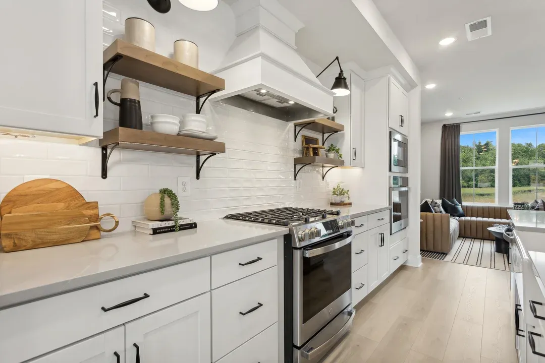 Kitchen with floating shelves and white cabinets
