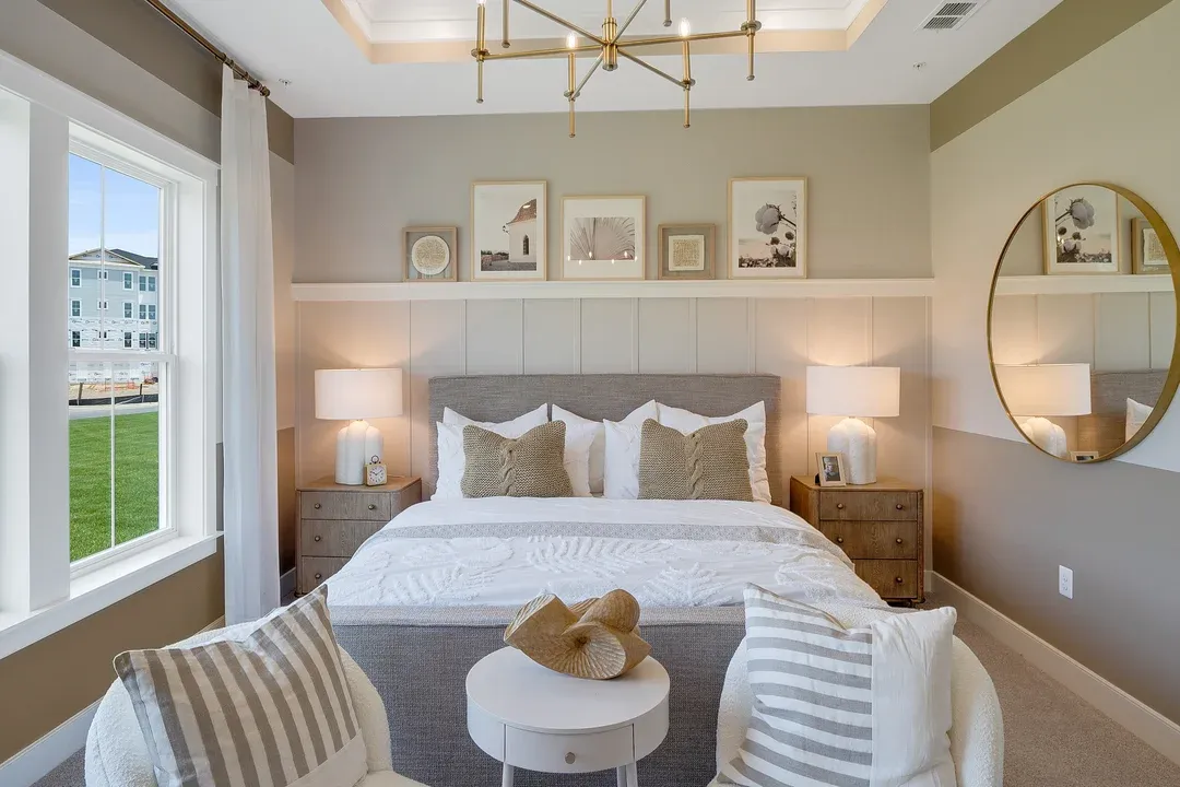 Primary suite with tray ceiling and decorative feature wall