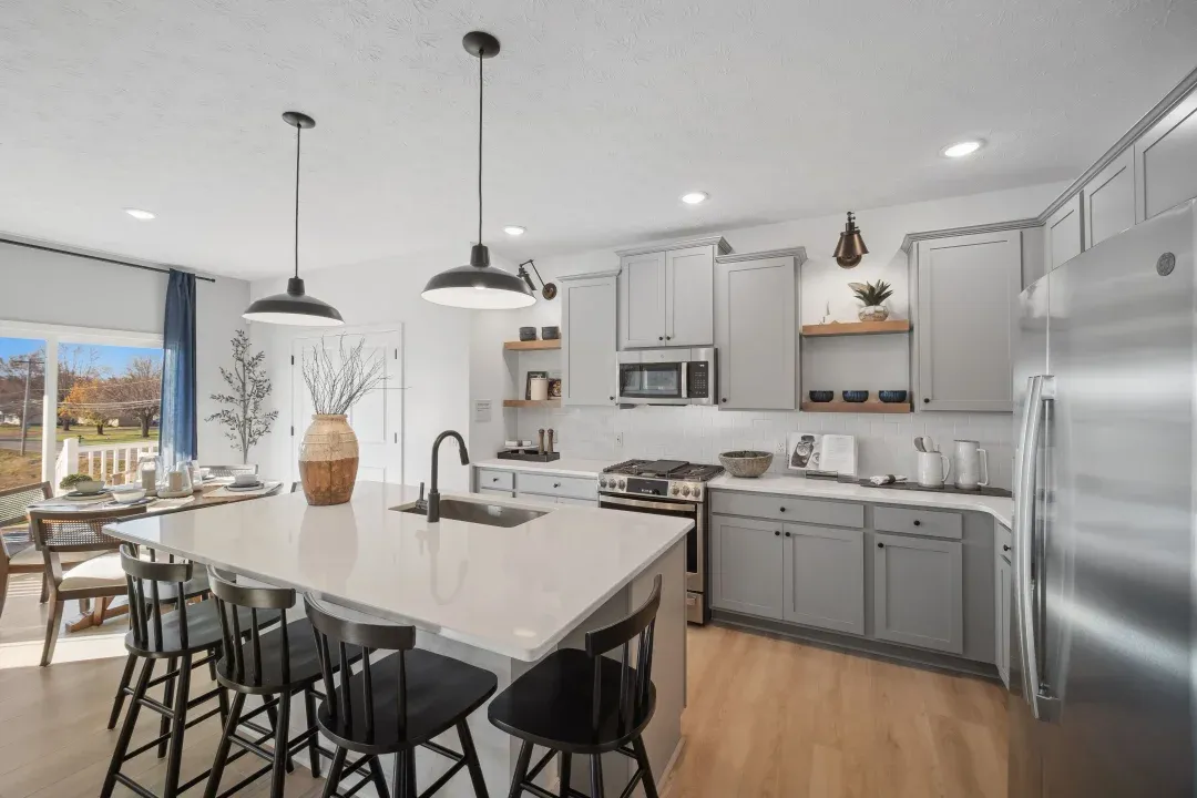 Kitchen with island, pendant lighting and open shelving