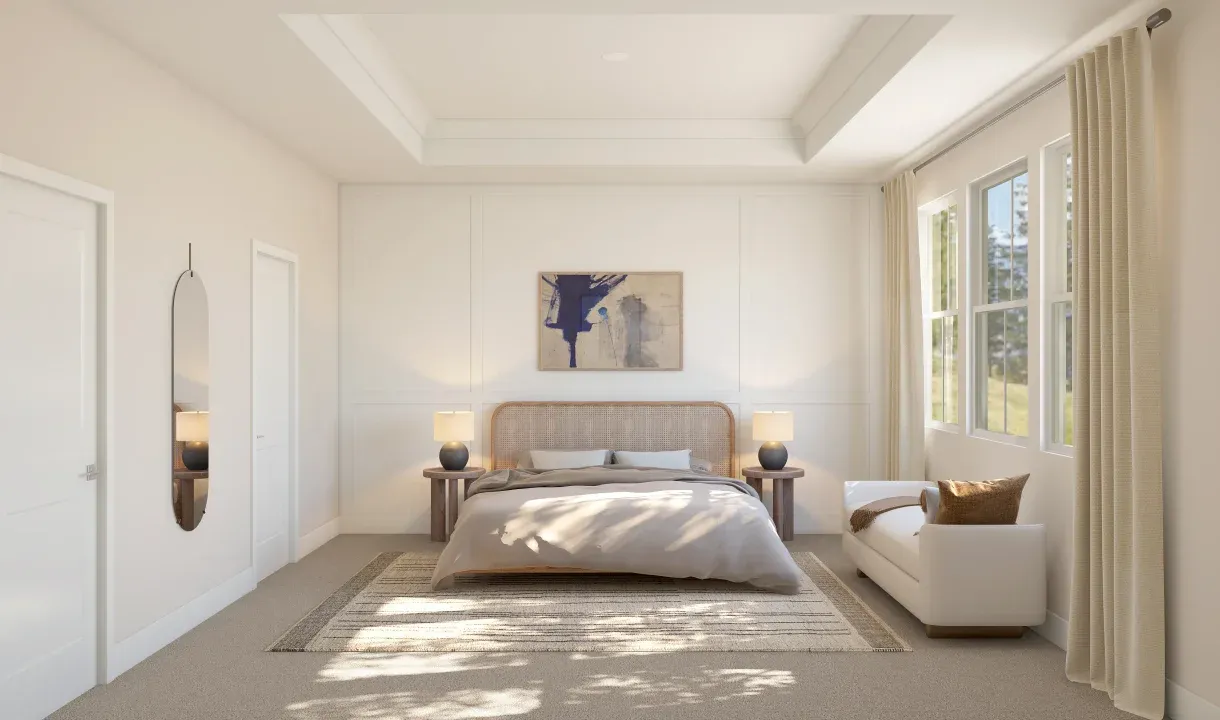 Primary suite with tray ceiling, crown moulding and decorative feature wall
