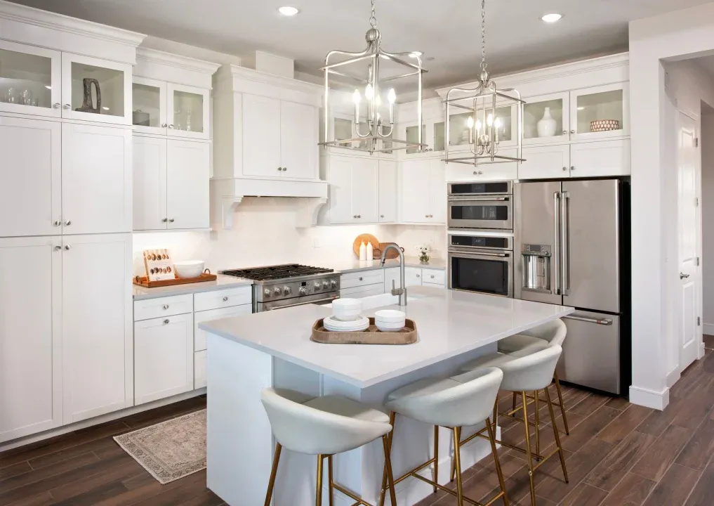 Kitchen with glass upper cabinets and pendant lighting
