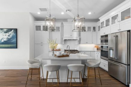 Kitchen with glass upper cabinets and pendant lighting