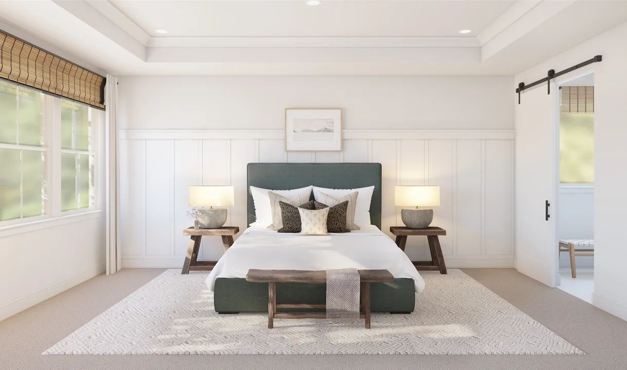 Primary suite with tray ceiling and decorative feature wall