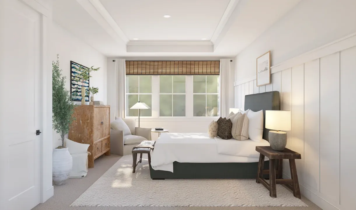 Primary suite with tray ceiling and decorative feature wall