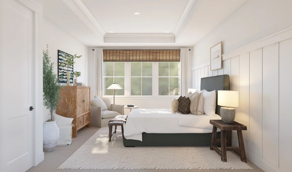 Primary suite with tray ceiling and decorative feature wall