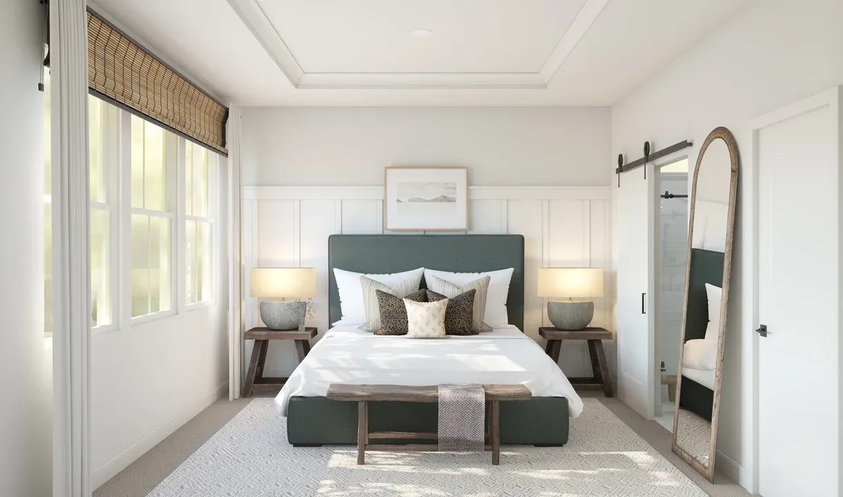 Primary suite with tray ceiling and decorative feature wall