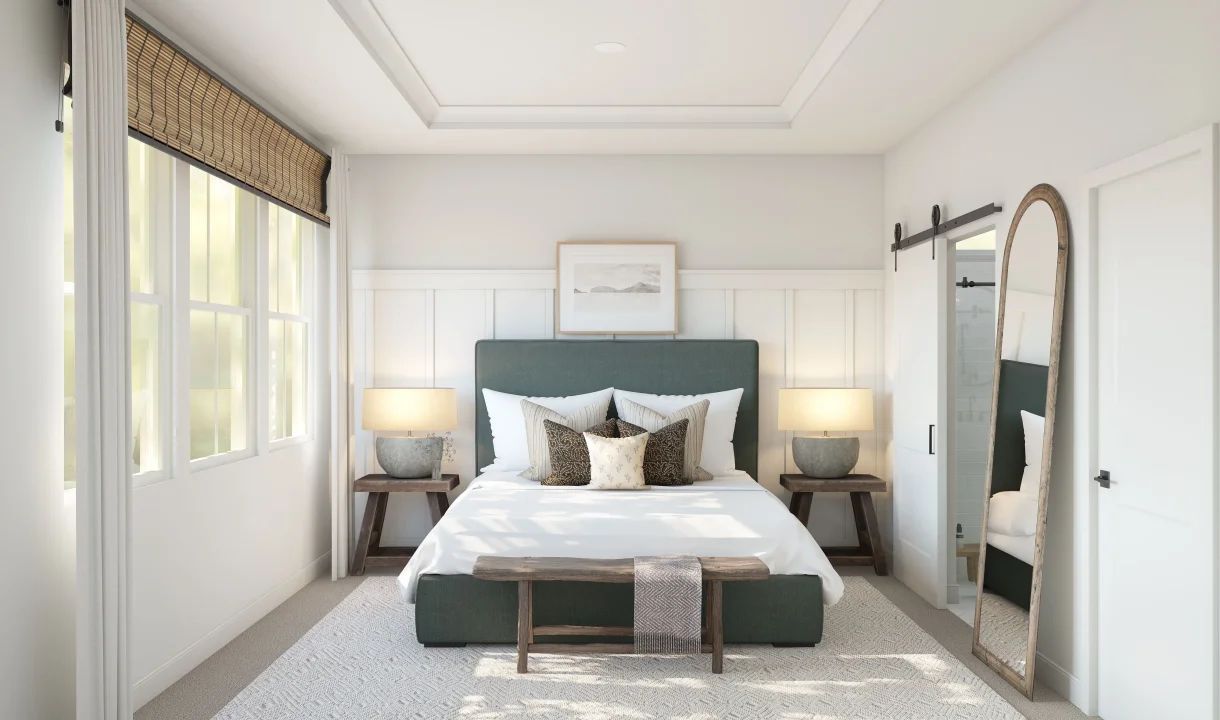 Primary suite with tray ceiling and decorative feature wall