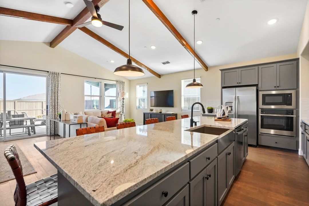 Kitchen with vaulted ceiling and stained ceiling beams
