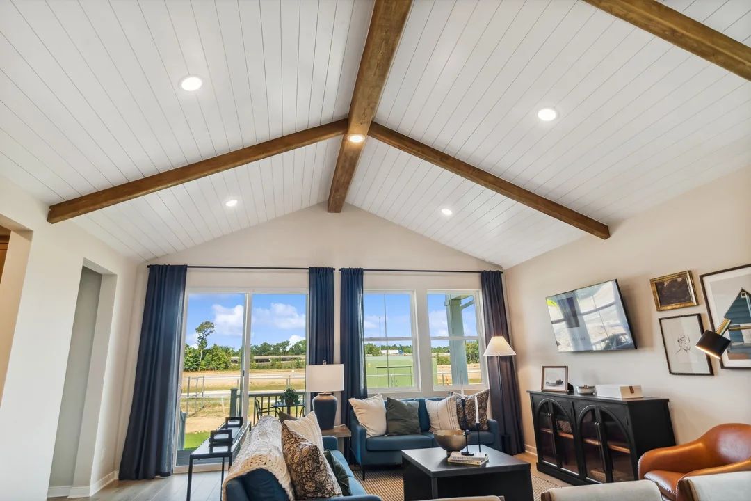 Soaring vaulted ceiling with stained beams and shiplap detail