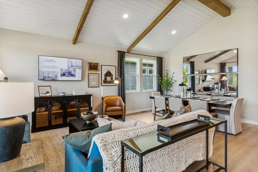 Open main living area with stained ceiling beams