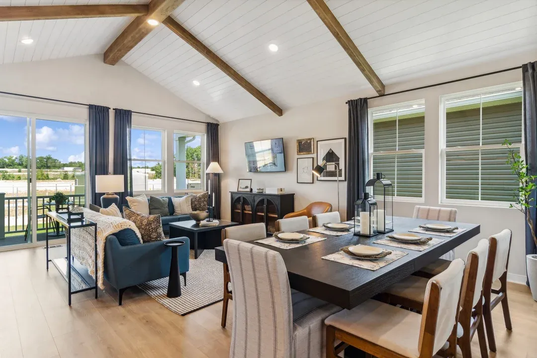 Dining area and great room connect to the covered patio