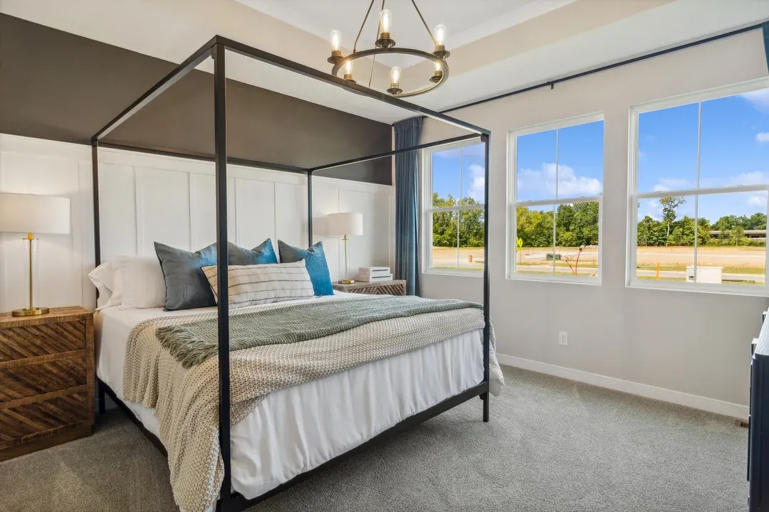 Primary suite with decorative feature wall and designer lighting