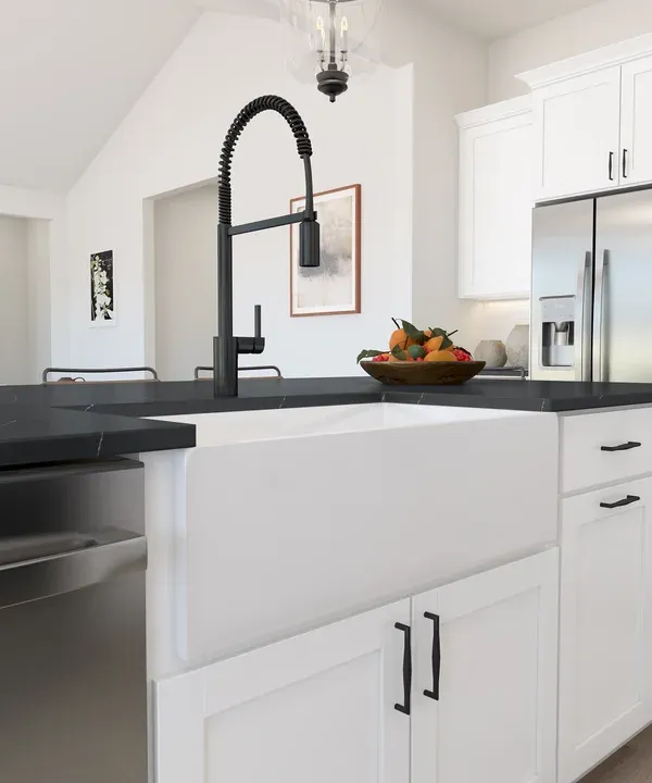 White apron-front farmhouse sink and matte black faucet
