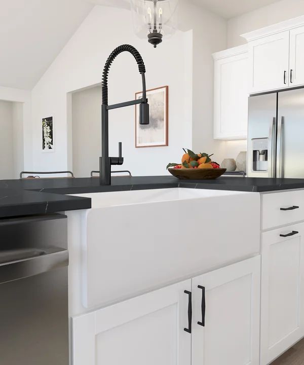 White apron-front farmhouse sink and matte black faucet