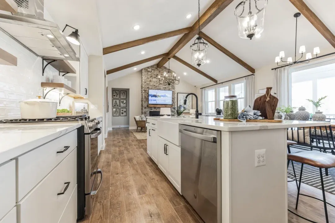 Kitchen with stained ceiling beams & vaulted ceiling