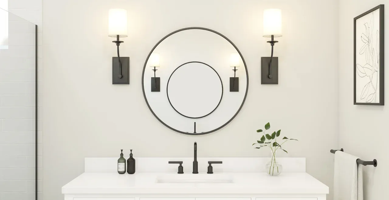 Primary bath with circular mirrors and matte black fixtures
