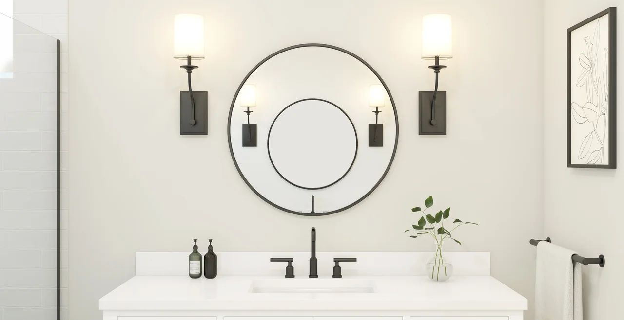 Primary bath with circular mirrors and matte black fixtures