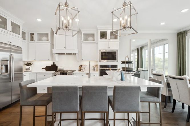 Kitchen with pendant lighting and glass upper cabinetry