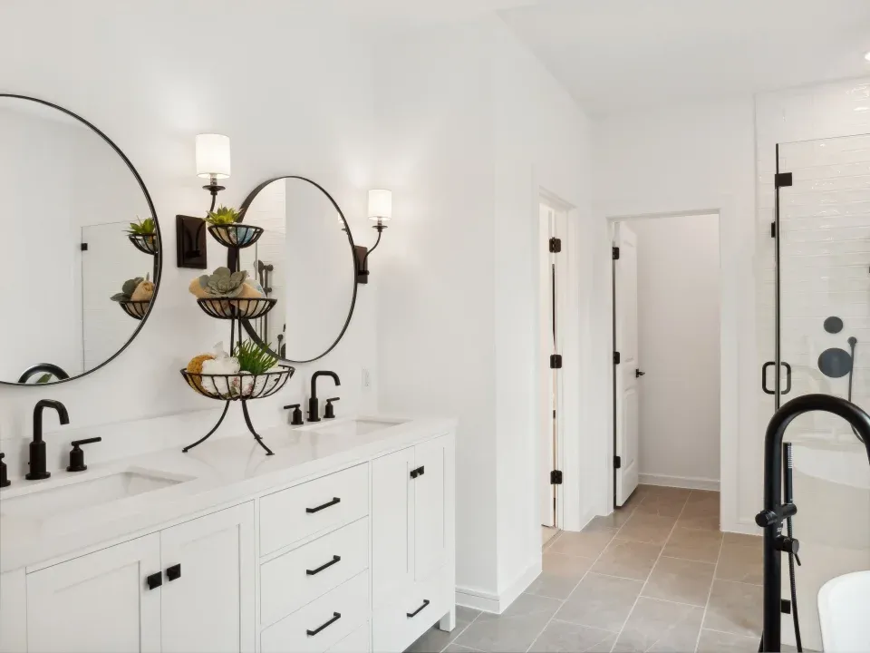 Primary bath with dual mirrors and sconce lighting