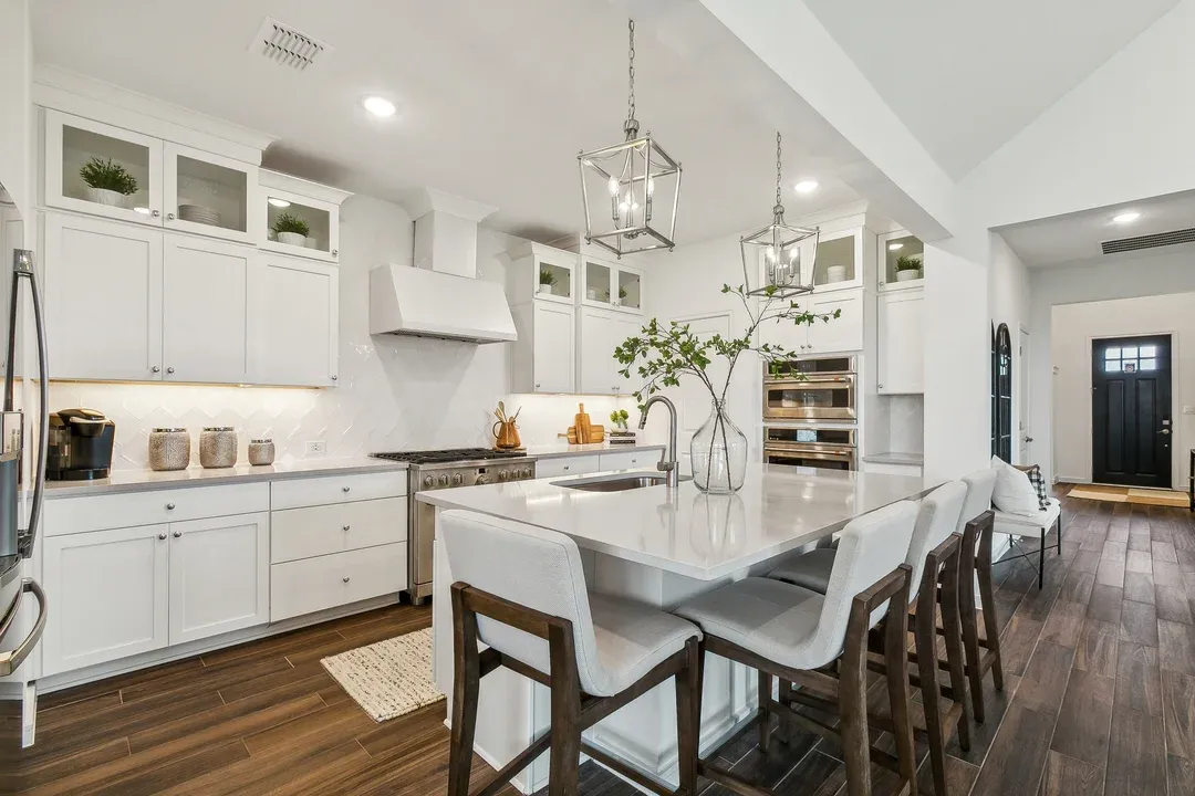 Kitchen with pendant lighting and glass upper cabinets