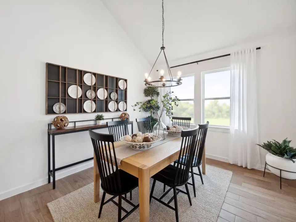 Dining area with vaulted ceiling and chandelier