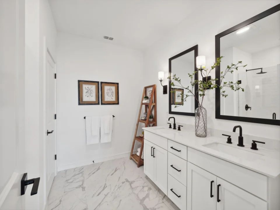 Primary bath features vanity with dual sinks