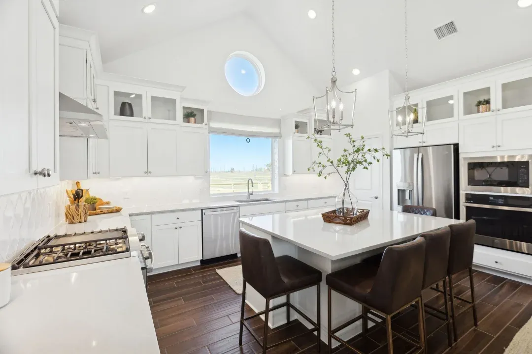 Kitchen with glass upper cabinets and vaulted ceiling