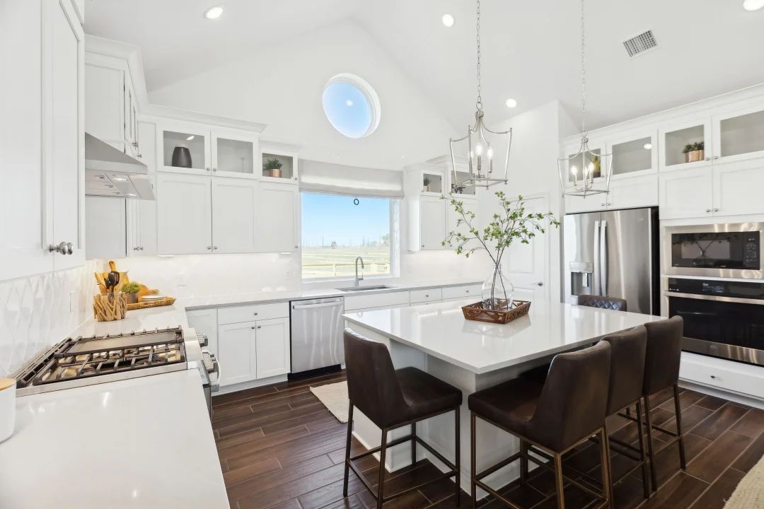 Kitchen with glass upper cabinets and vaulted ceiling