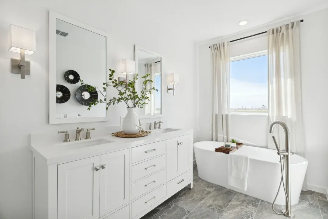 Primary bath features freestanding vanity with dual sinks