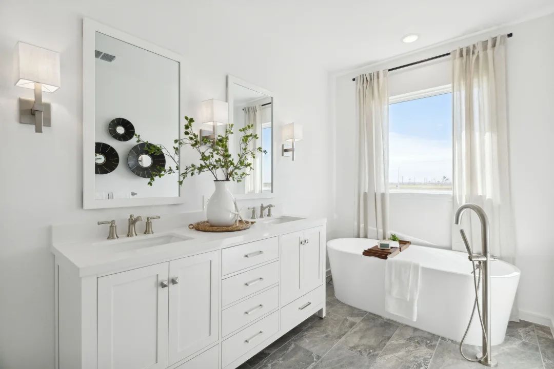 Primary bath features freestanding vanity with dual sinks