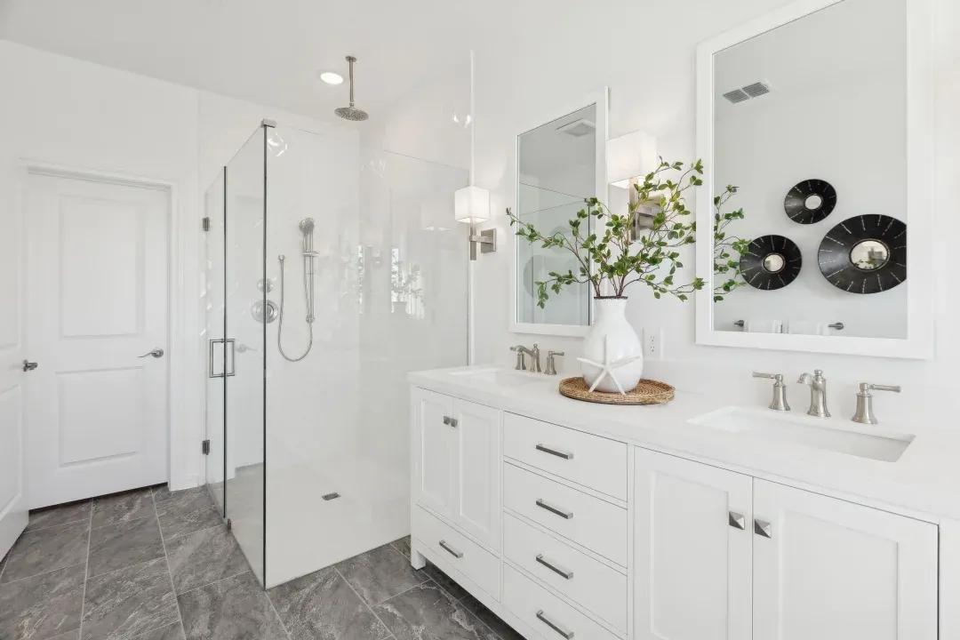 Primary bath with glass shower enclosure and freestanding vanity