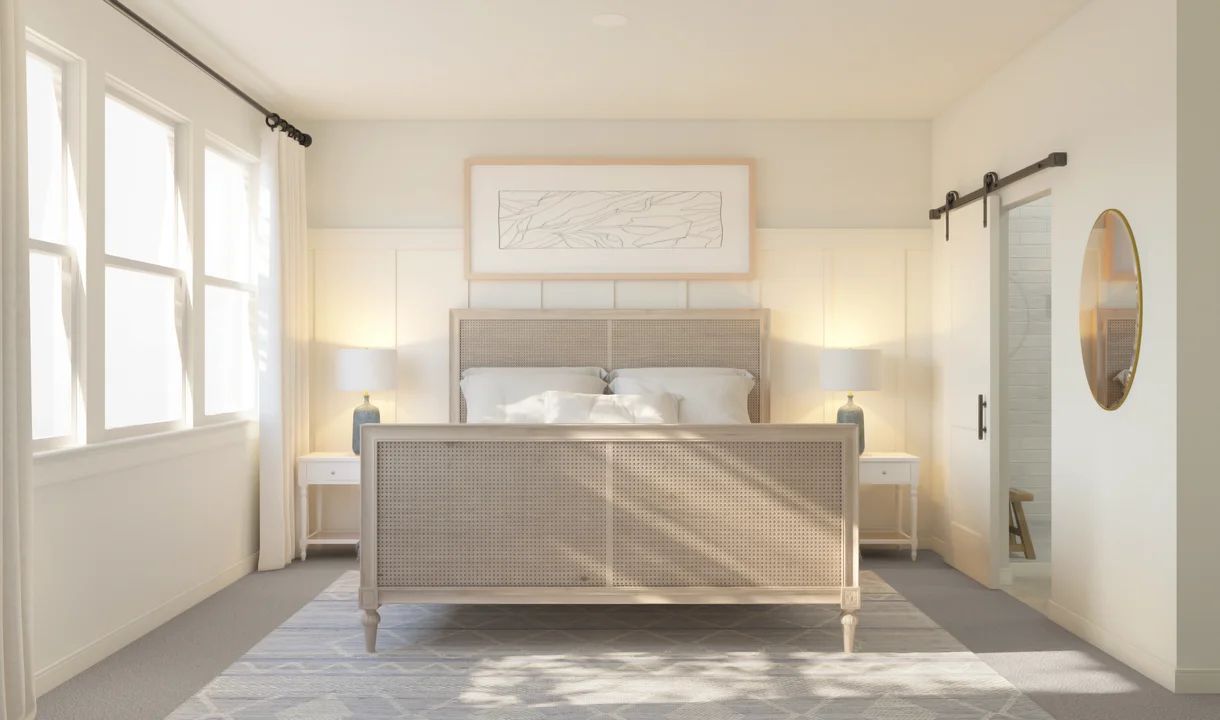 Primary suite with decorative feature wall and sliding barn door to private bath