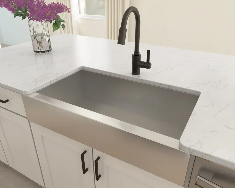 Kitchen features stainless steel apron-front sink