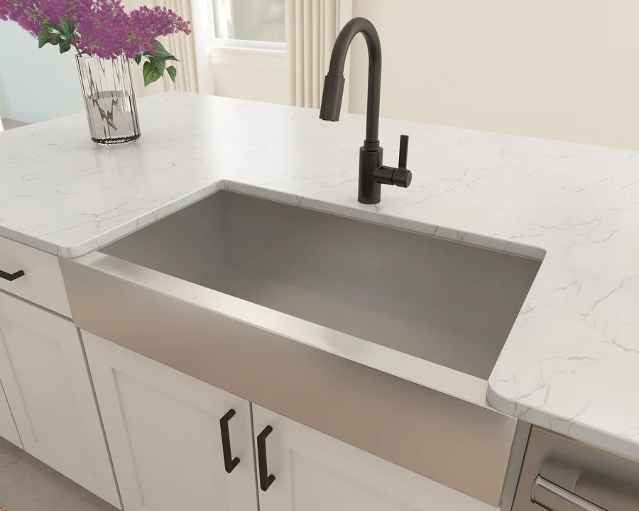 Kitchen features stainless steel apron-front sink
